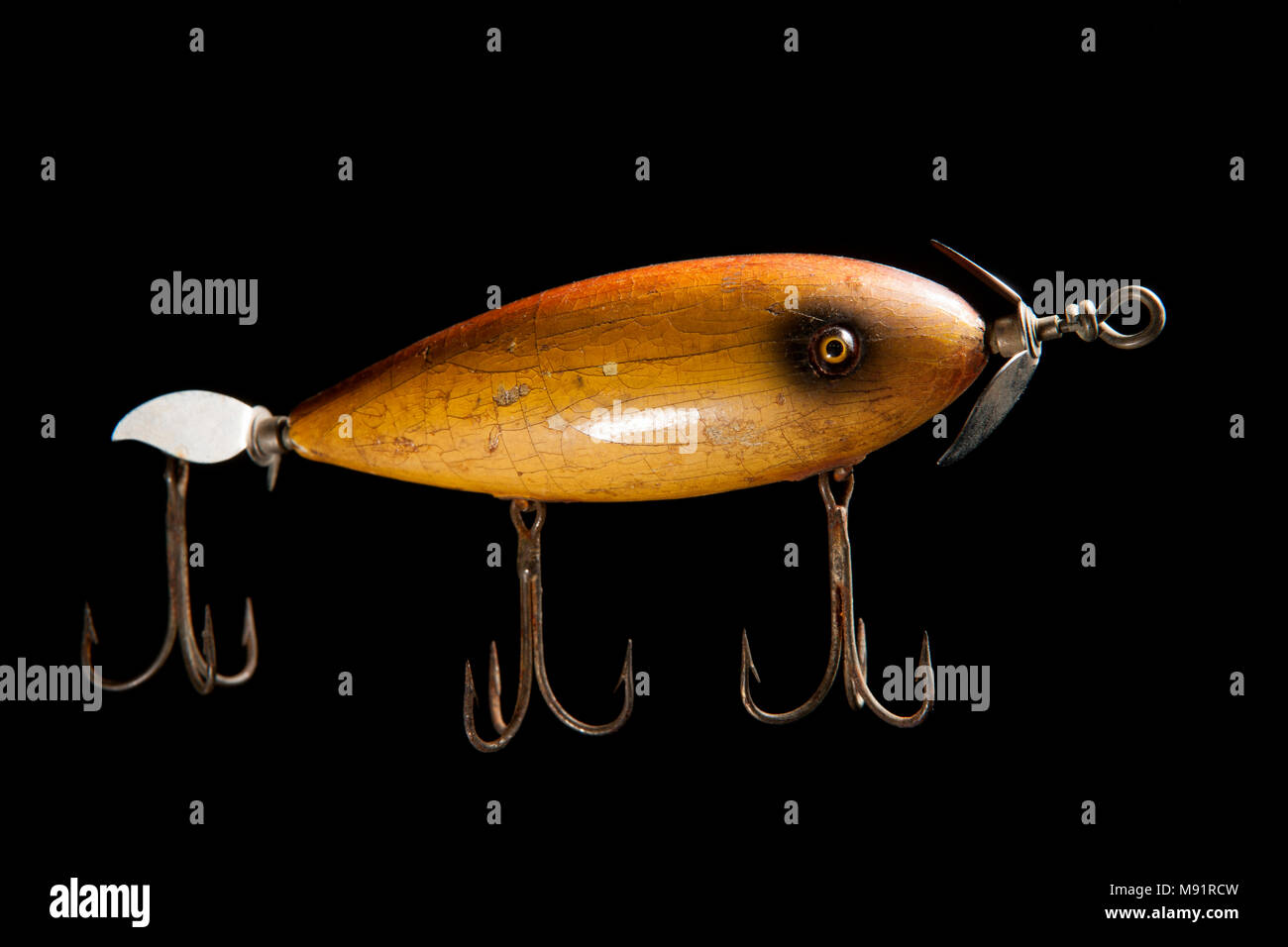 Old fishing lure or plug by South Bend, on a black background