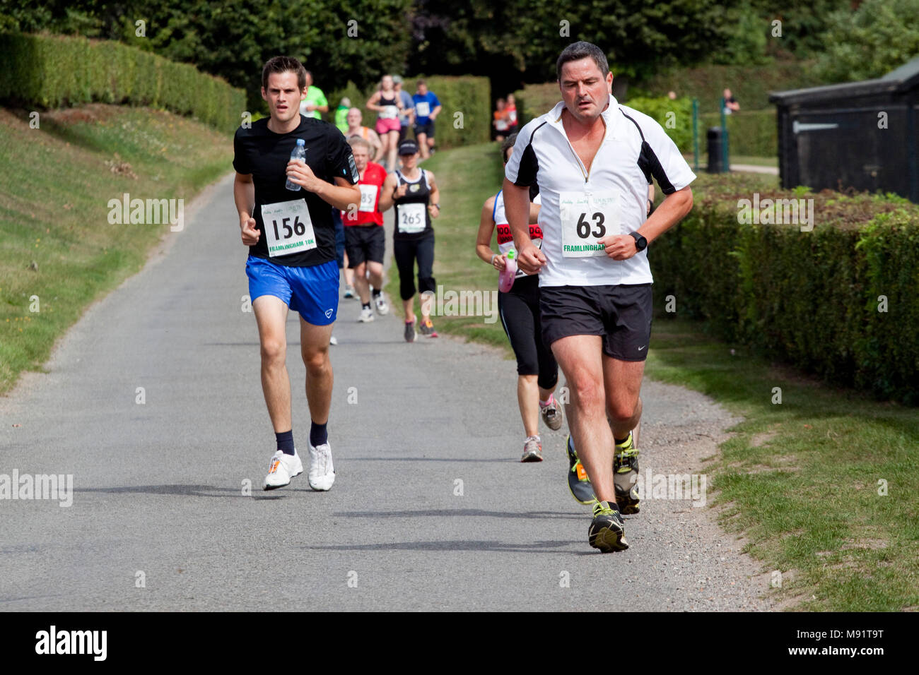 Runners on a country road competing in a 10km race Stock Photo - Alamy