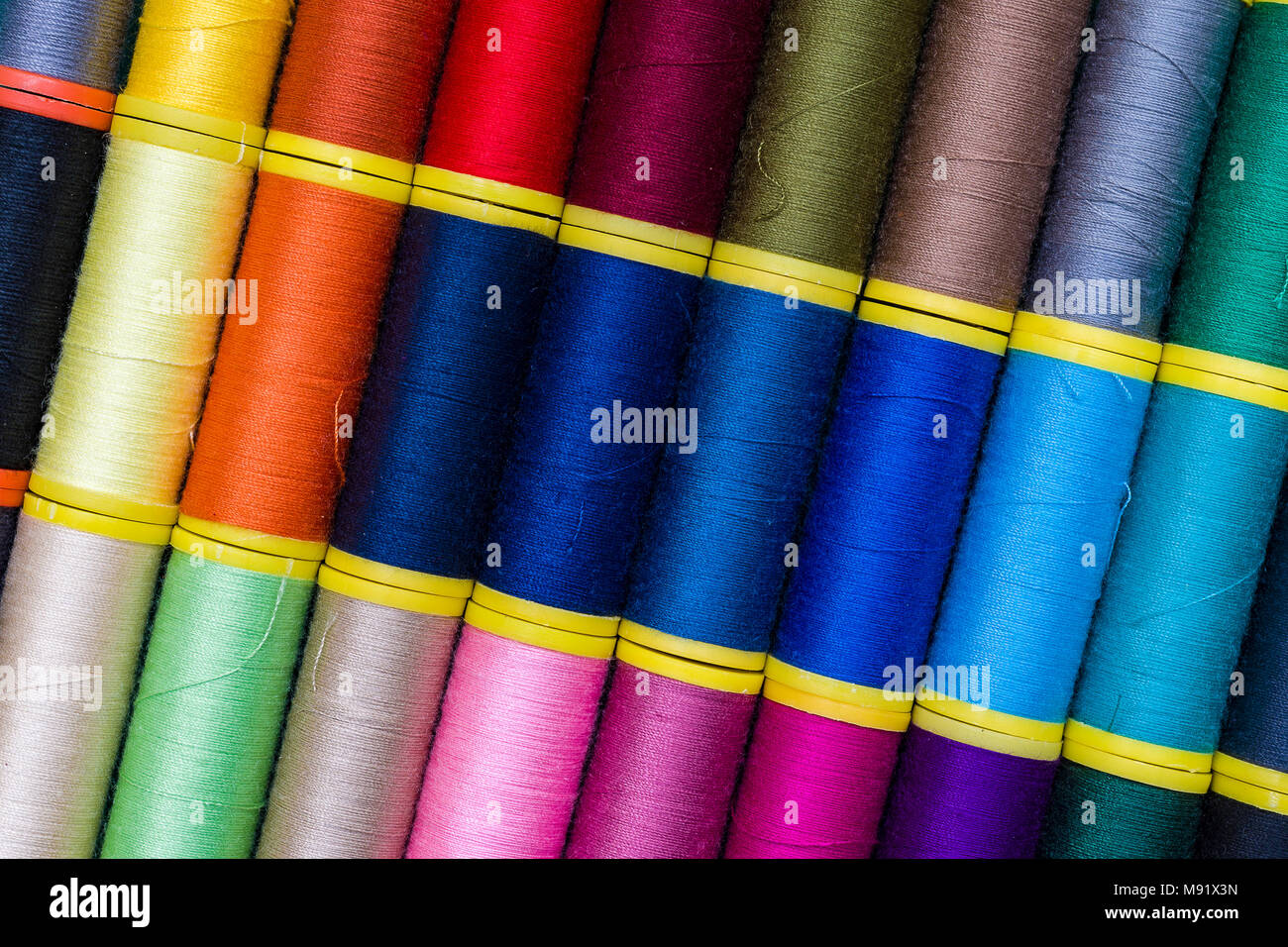 Background of colourful thread spools Colored threads in reels Stock ...