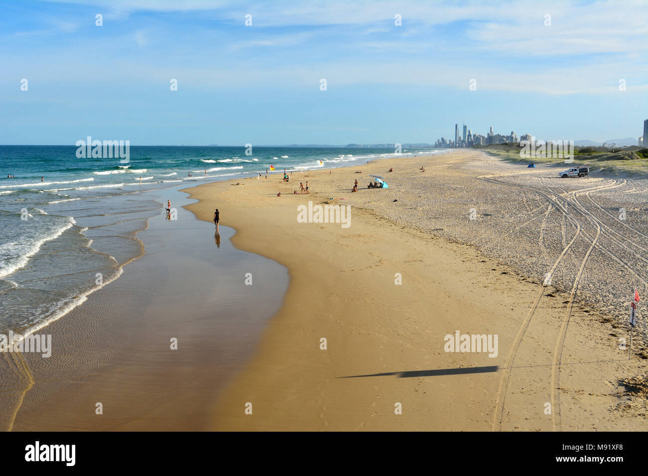Main Beach, Gold Coast, Queensland, Australia - January 10, 2018. Beach at the Spit, with people and skyscrapers of Surfers Paradise in the distance. Stock Photo