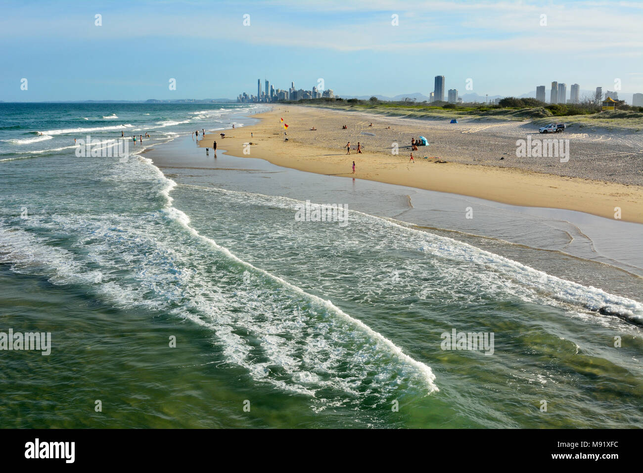 Main Beach, Gold Coast, Queensland, Australia - January 10, 2018. Beach at the Spit, with people and skyscrapers of Surfers Paradise in the distance. Stock Photo