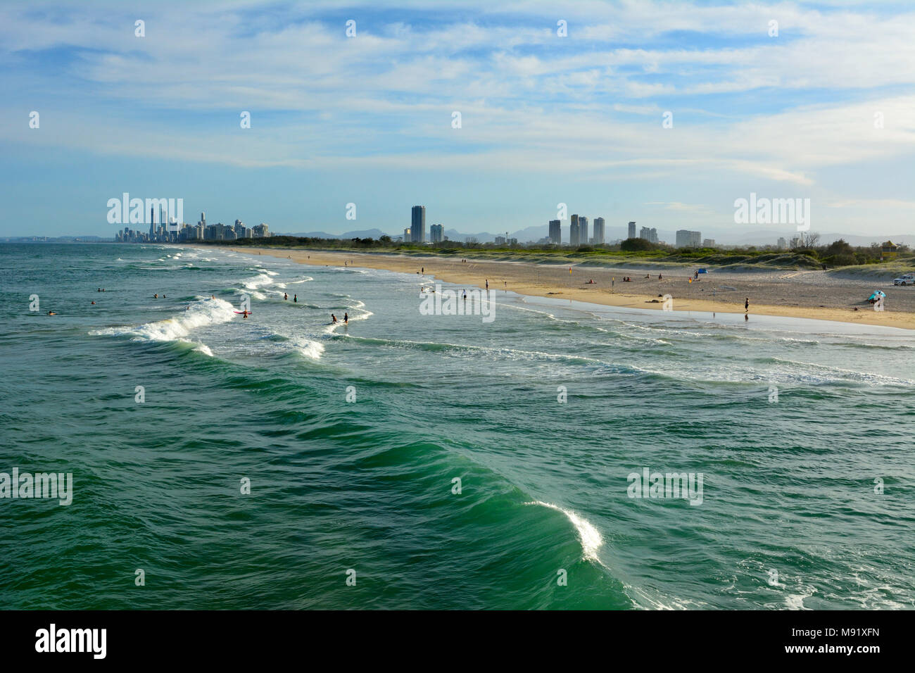 Beach at the Spit, with people and skyscrapers of Surfers Paradise in the distance. Stock Photo