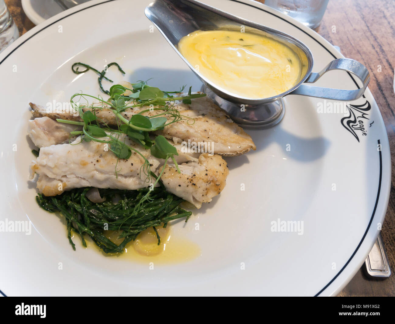 Roast Hake with  béarnaise, sauce and samphire served at the famous Magpie Café in historic  Whitby North Yorkshire England UK Stock Photo
