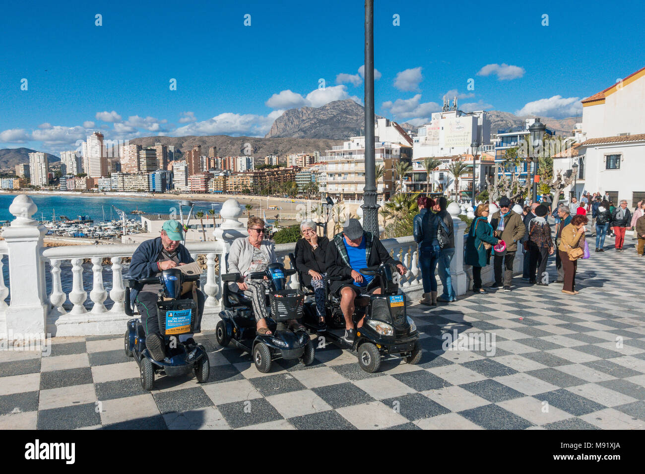 Group of elderly people on mobility scooters in Benidorm, Spain Stock Photo