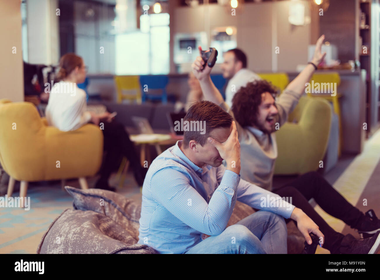 Work hard play hard. Workers Playing computer games in creative startup ...