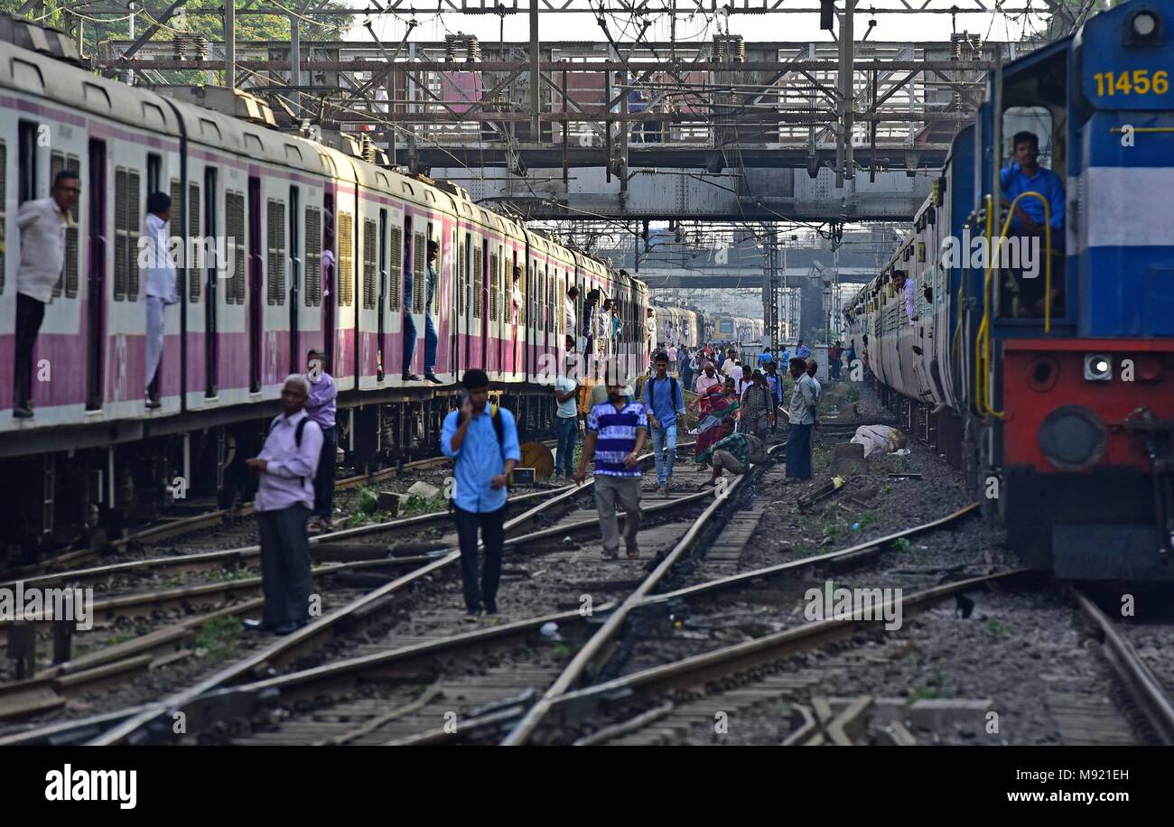 MUMBAI, INDIA - MARCH 20: Commuters walking on the track between 