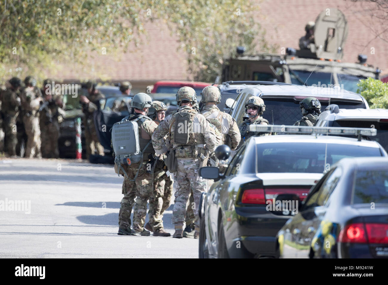 Police SWAT teams secure the Pflugerville, TX, neighborhood around the home of Mark Conditt, who was the suspected serial bomber terrorizing Austin for three weeks. Conditt killed himself earlier in the day during a car chase as officers closed in. Stock Photo