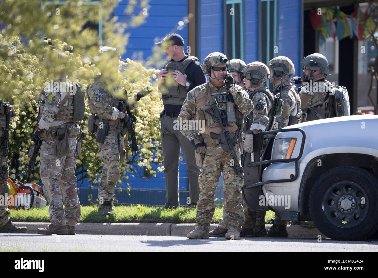 Police SWAT teams secure the Pflugerville, TX, neighborhood around the home of Mark Conditt, who was the suspected serial bomber terrorizing Austin for three weeks. Conditt killed himself earlier in the day during a car chase as officers closed in. Stock Photo