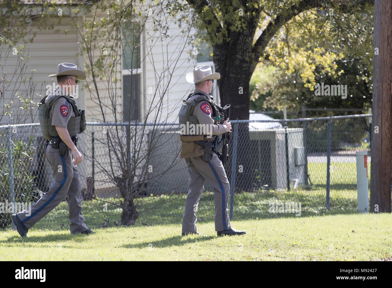 Texas state troopers help secure the Pflugerville, TX, neighborhood around the home of Mark Conditt, who was the suspected serial bomber terrorizing Austin for three weeks. Conditt killed himself earlier in the day during a car chase as officers closed in. Stock Photo