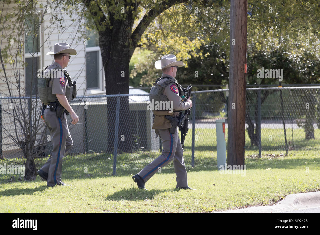 Texas state troopers help secure the Pflugerville, TX, neighborhood around the home of Mark Conditt, who was the suspected serial bomber terrorizing Austin for three weeks. Conditt killed himself earlier in the day during a car chase as officers closed in. Stock Photo