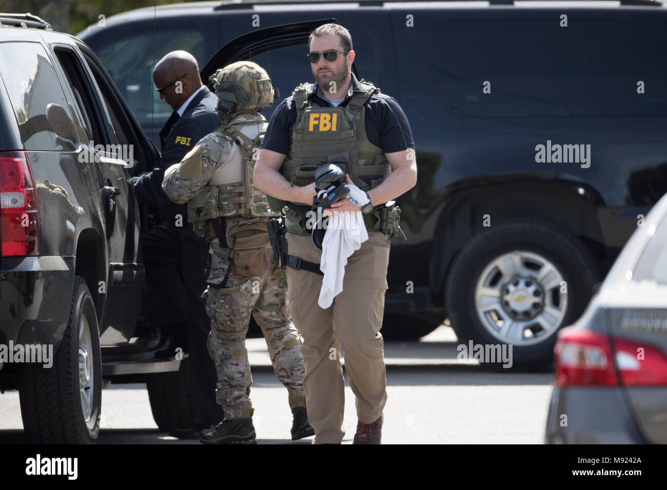 FBI agents help secure the Pflugerville, TX, neighborhood around the home of Mark Conditt, who was the suspected serial bomber terrorizing Austin for three weeks. Conditt killed himself earlier in the day during a car chase as officers closed in. Stock Photo