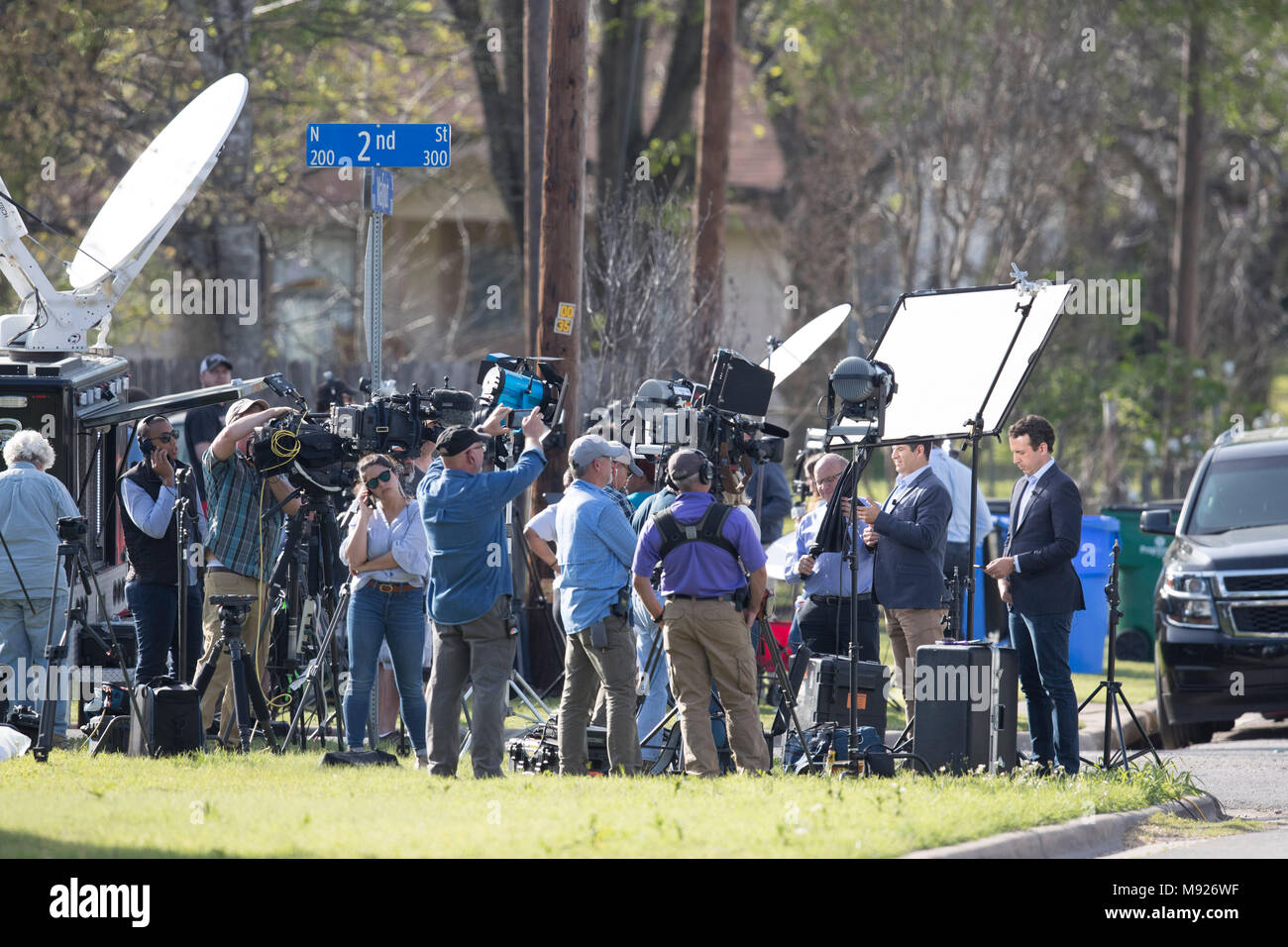 A crush of reporters gathers to cover a breaking news story in a neighborhood in Pflugeville, TX. Stock Photo