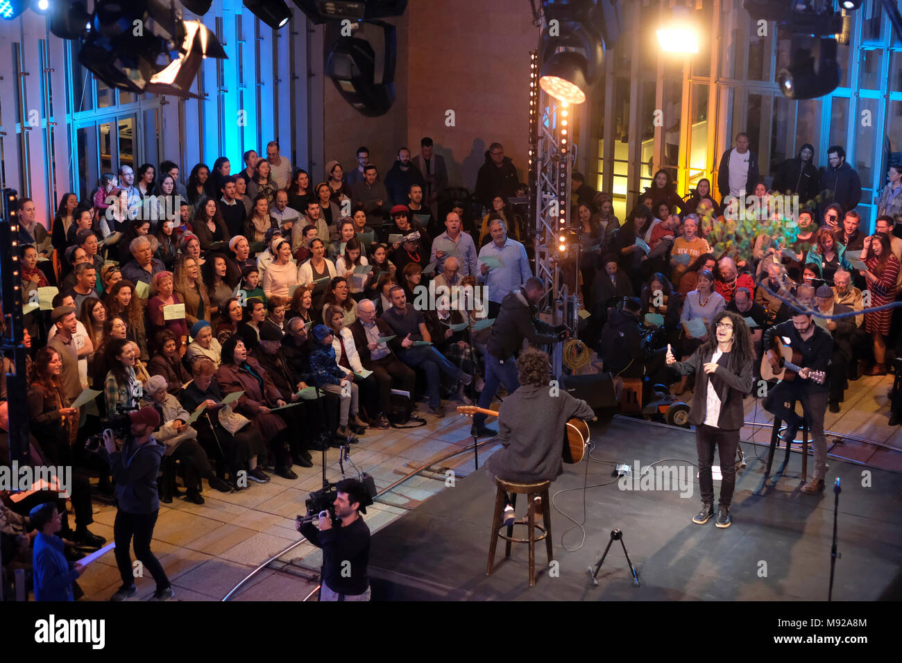 Holocaust survivors and their families gather to record live the song “Chai” or “Alive” first performed by the late international Israeli artist Ofra Haza at Beit Avi Chai Jewish culture institution in Jerusalem. Stock Photo