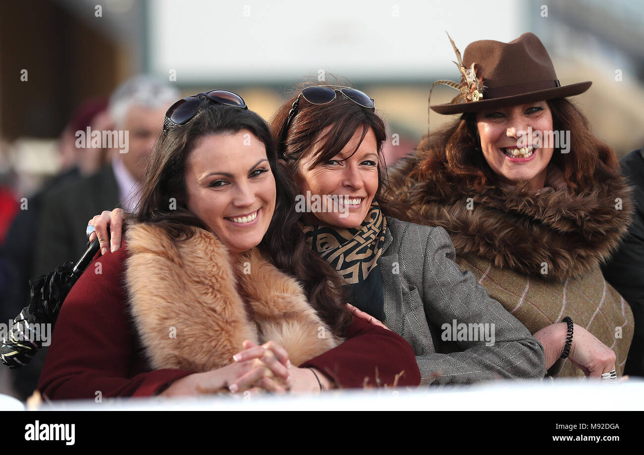 Female racegoers watch the action in the St. James's Place Foxhunter Challenge Cup Open Hunters' Chase during Gold Cup Day of the 2018 Cheltenham Festival at Cheltenham Racecourse. Stock Photo