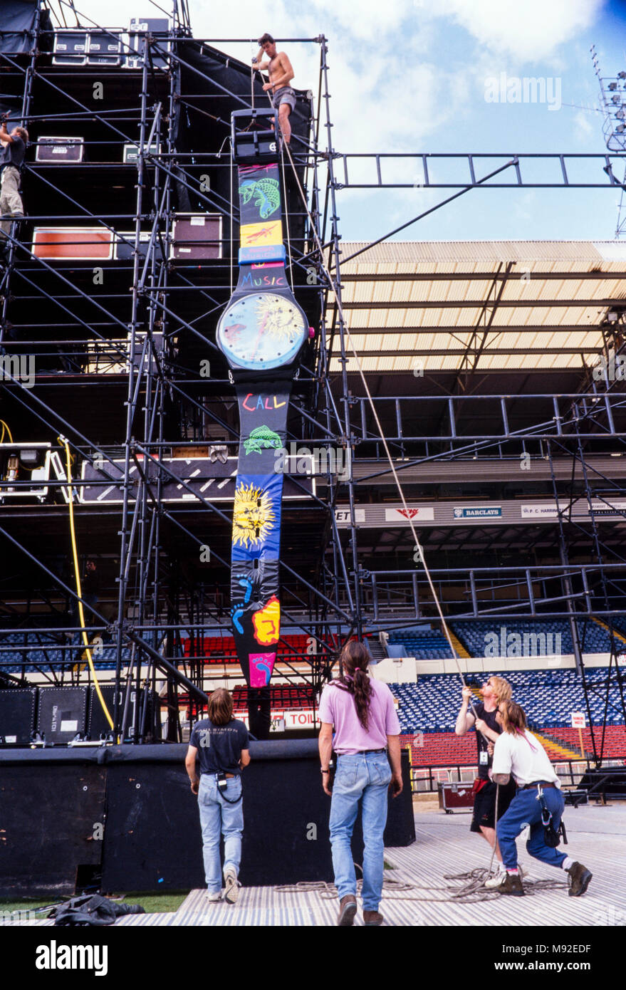 Stage crew hauling up a giant Swatch watch on to scaffolding, Jean Michel Jarre concert at wembley Stadium, 28th August 1993, archival photograph, london, England Stock Photo