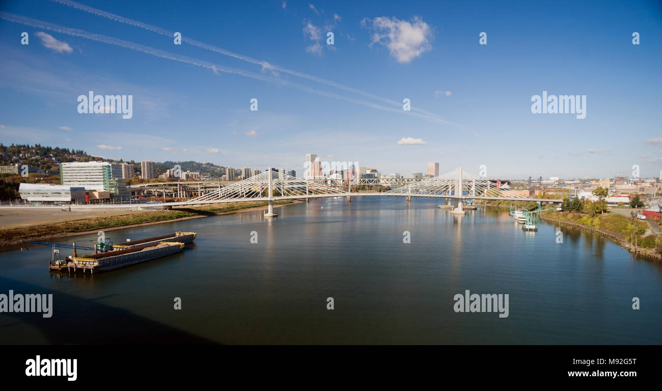 It's a clear day in Portland Oregon at Tilikum Crossing as people traverse the river Stock Photo