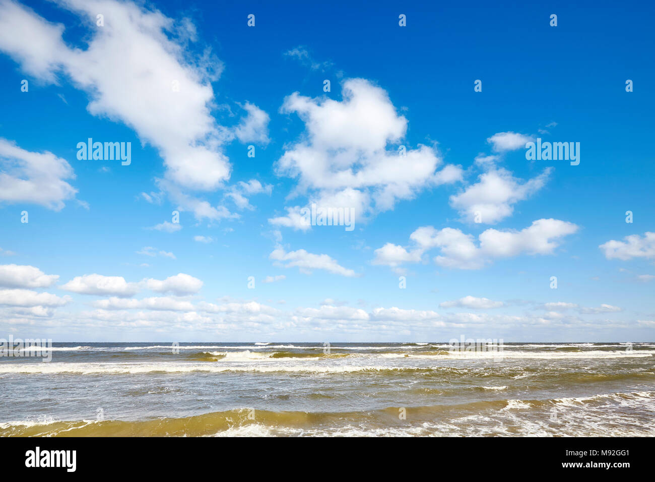 Blue sky with clouds over a sea. Stock Photo