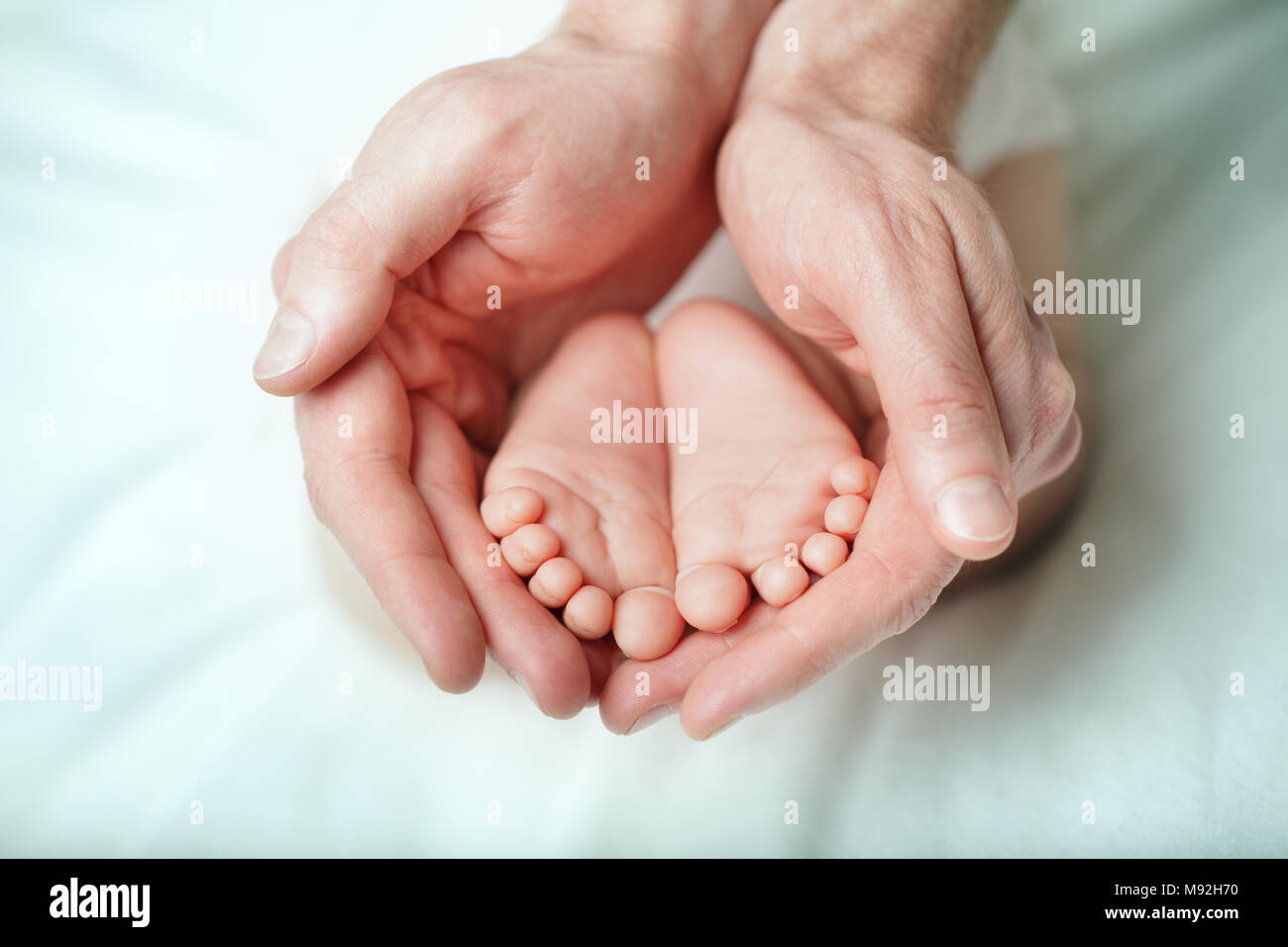 Parental care - sweet baby, foot macro Stock Photo
