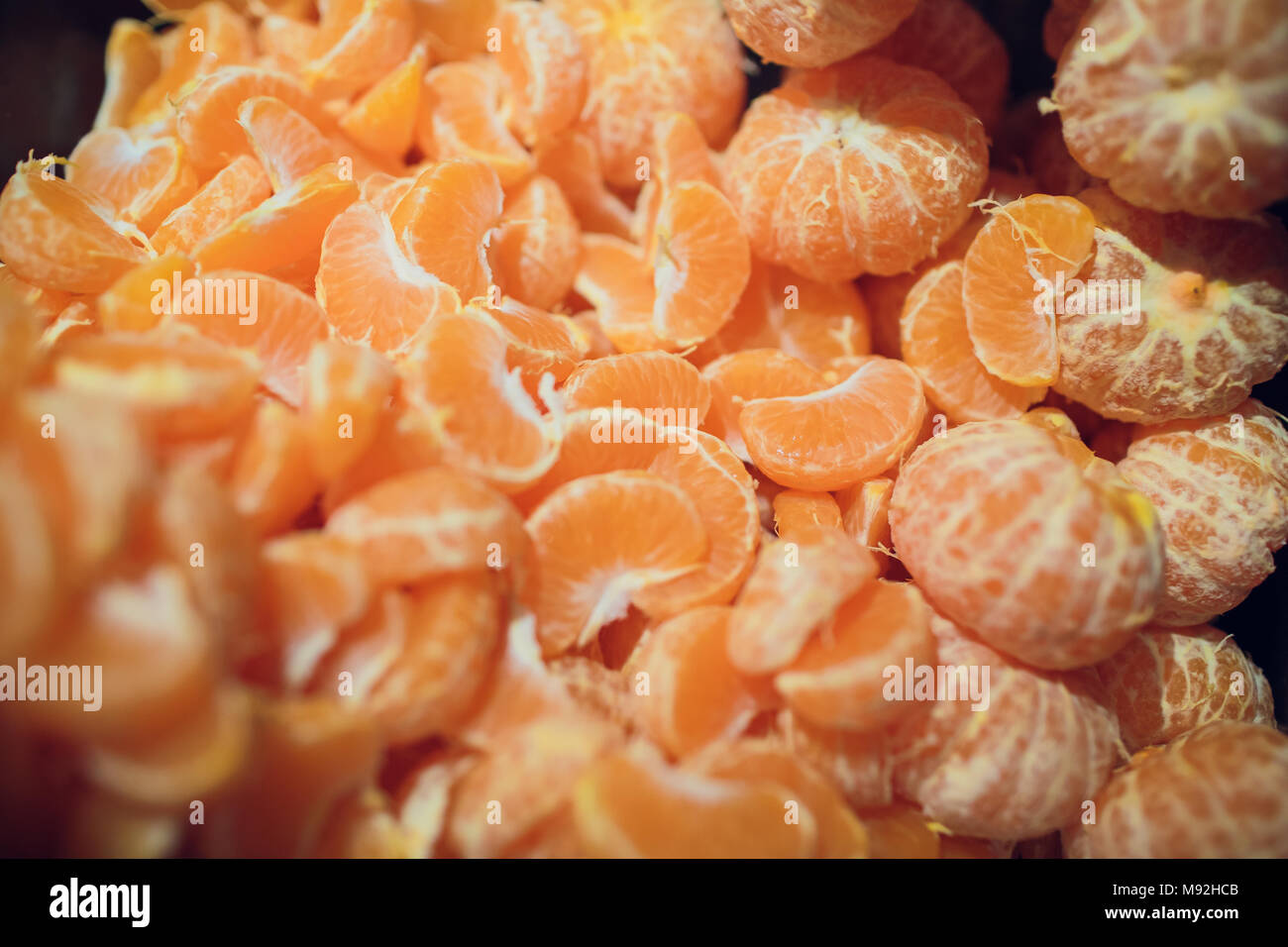 To clean tangerine. To remove a peel from tangerine. Cleaning of a madarin  of a peel. Food Stock Photo - Alamy