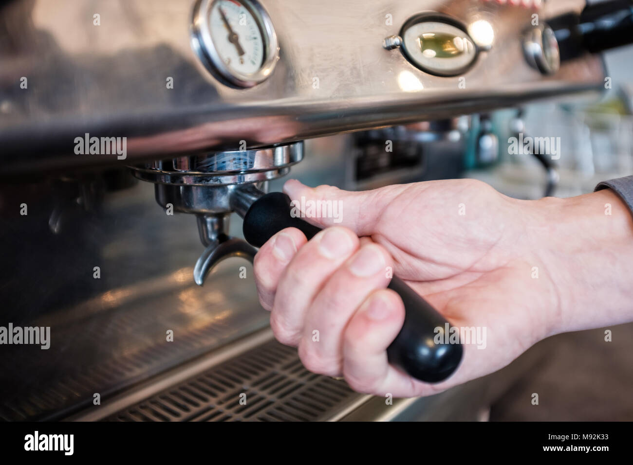 Barista locking portafilter with coffee in grouphead of coffee machine