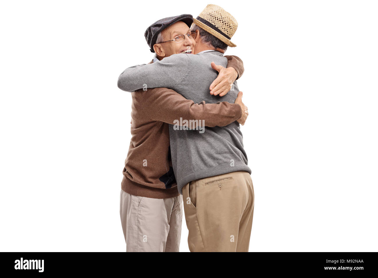 Two elderly men hugging each other isolated on white background Stock Photo