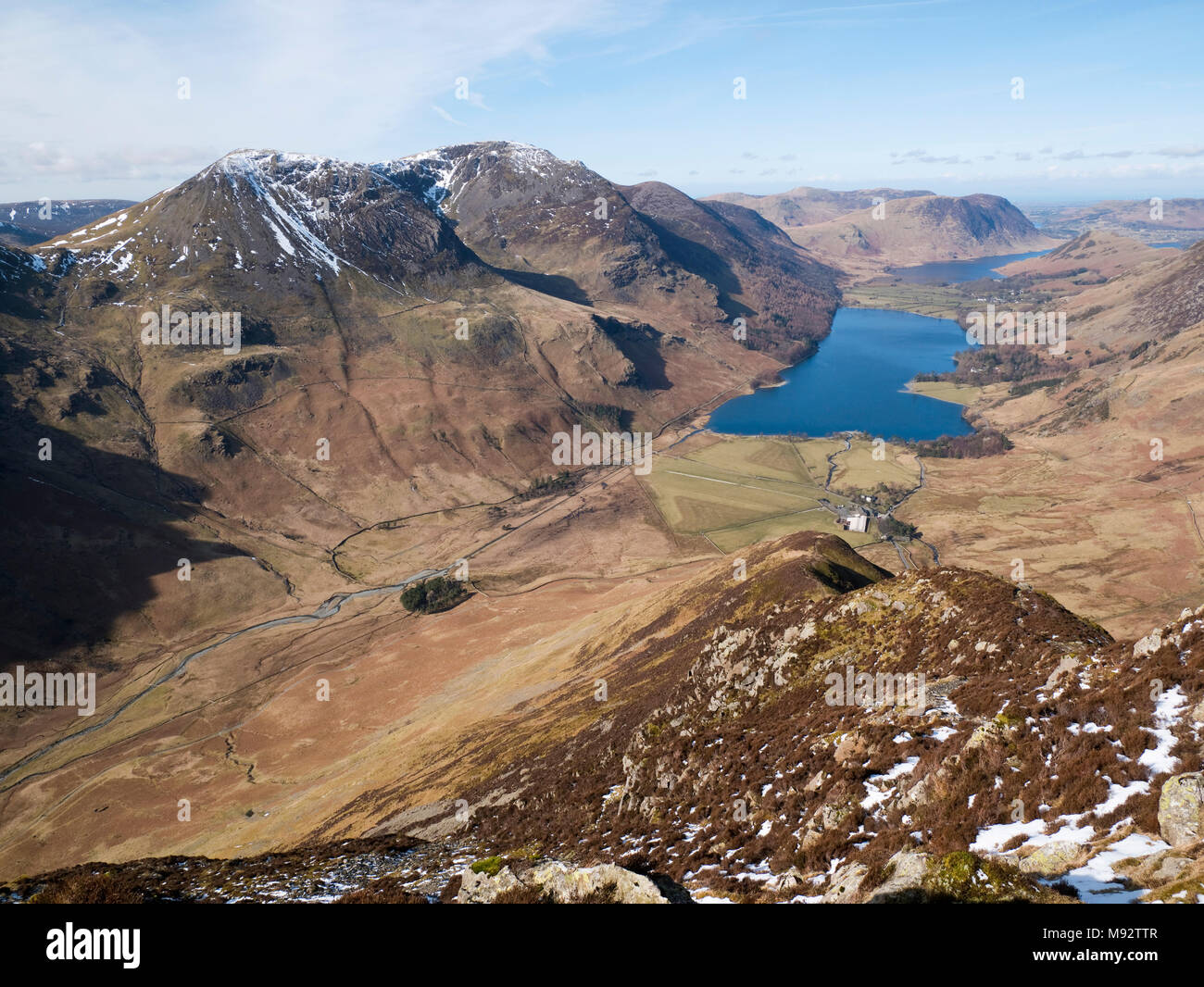 View to Buttermere & Crummock Water from Fleetwith Edge on Fleetwith Pike. The Buttermere Fells rise left while Mellbreak rises over Crummock Water Stock Photo