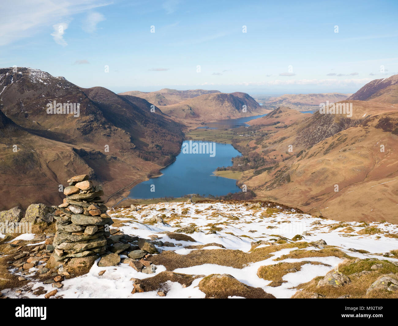 View along Buttermere to Crummock Water from Fleetwith Pike summit. The Buttermere Fells rise left while Mellbreak rises over Crummock Water Stock Photo