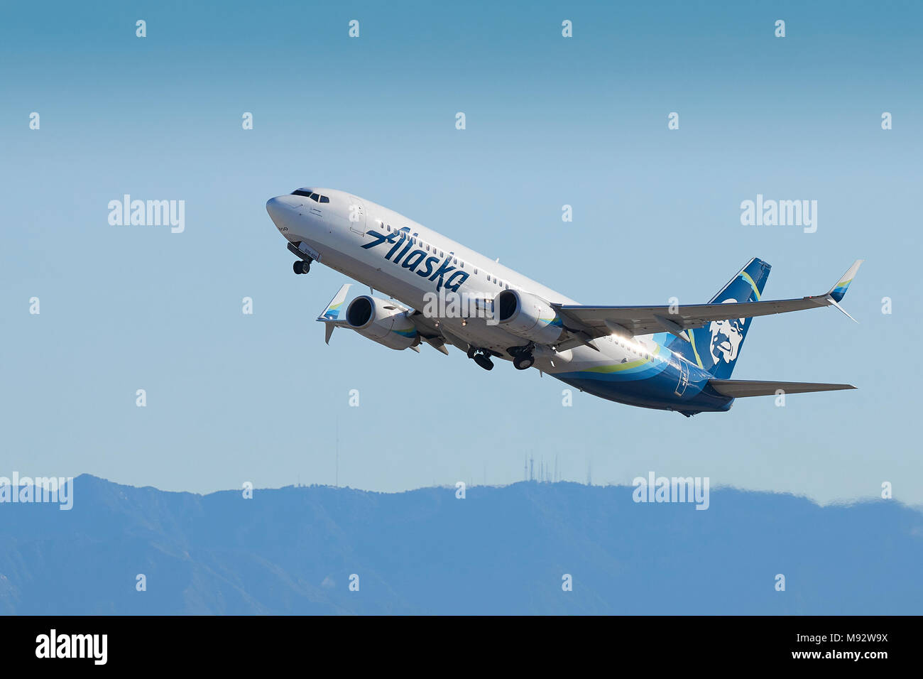 Alaska Airlines Boeing 737-800 Jet Airliner Taking Off From Los Angeles International Airport, LAX. The San Gabriel Mountains In Background. Stock Photo