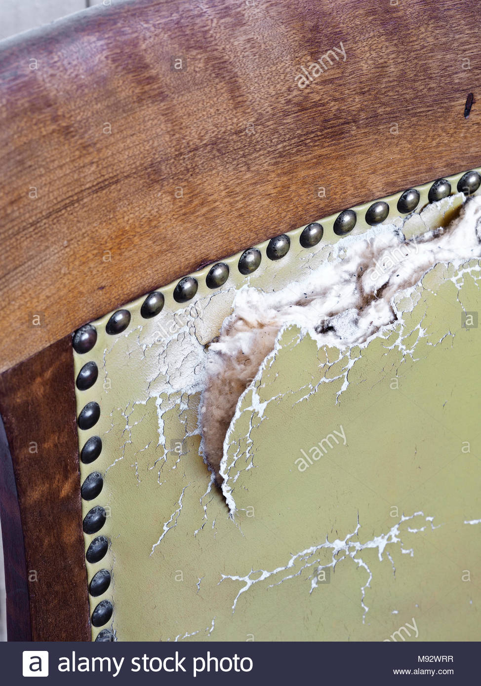 Wooden Chair With Worn Stuffing With Copy Space Stock Photo