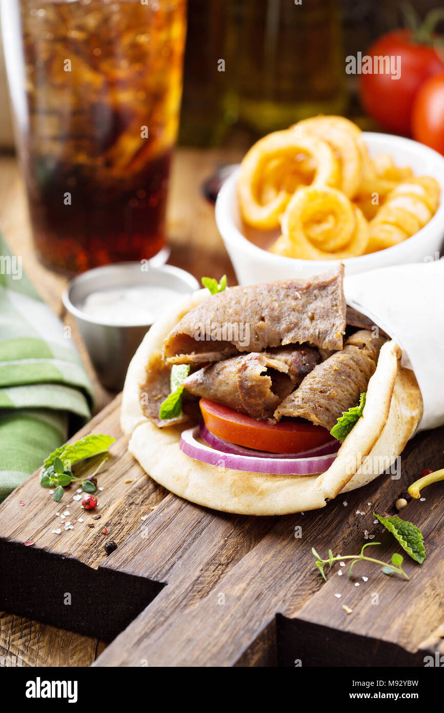 Greek gyro pita wrap with curly fries Stock Photo Alamy