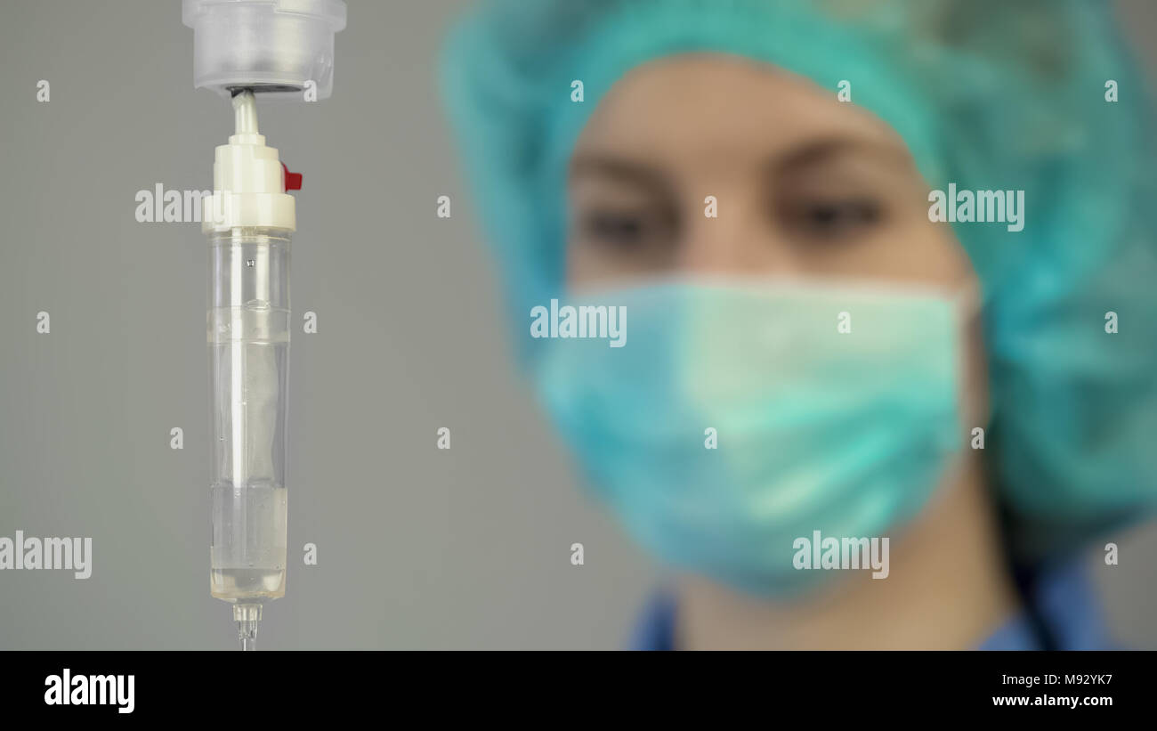 Clinic worker near drop counter, intravenous therapy, medical care, reanimation Stock Photo Alamy