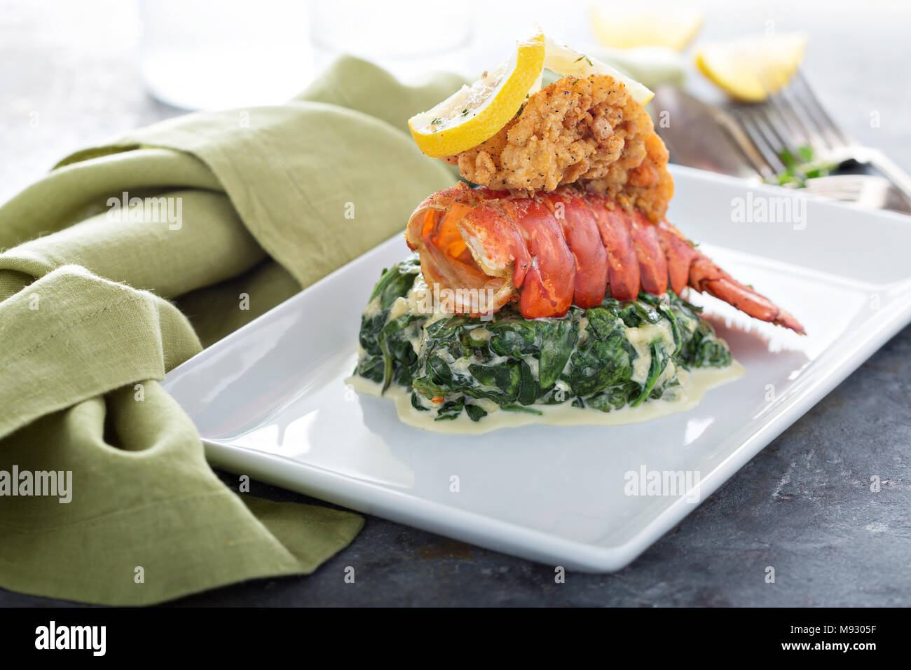 Fried lobster tail with cremy spinach and lemon Stock Photo Alamy