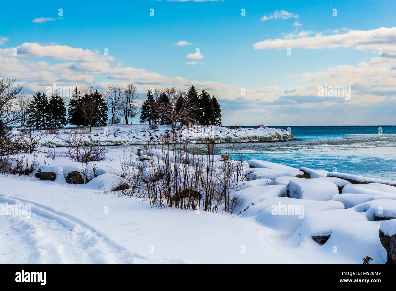 Winter Landscape Scene showing white snow along icy water lake coastal ...