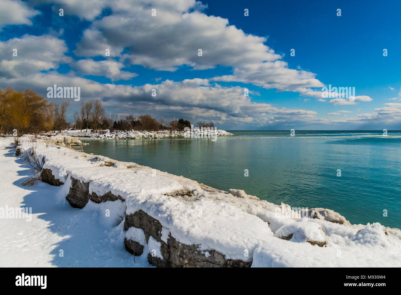 Winter Landscape Scene showing white snow along icy water lake coastal ...
