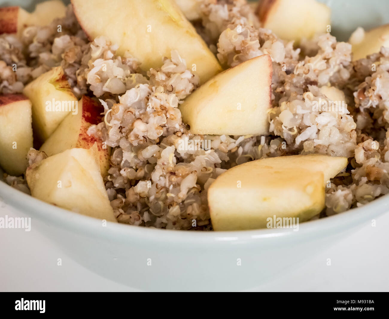 Healthy breakfast option, warm muesli with quinoa and oats and apple pieces. Stock Photo