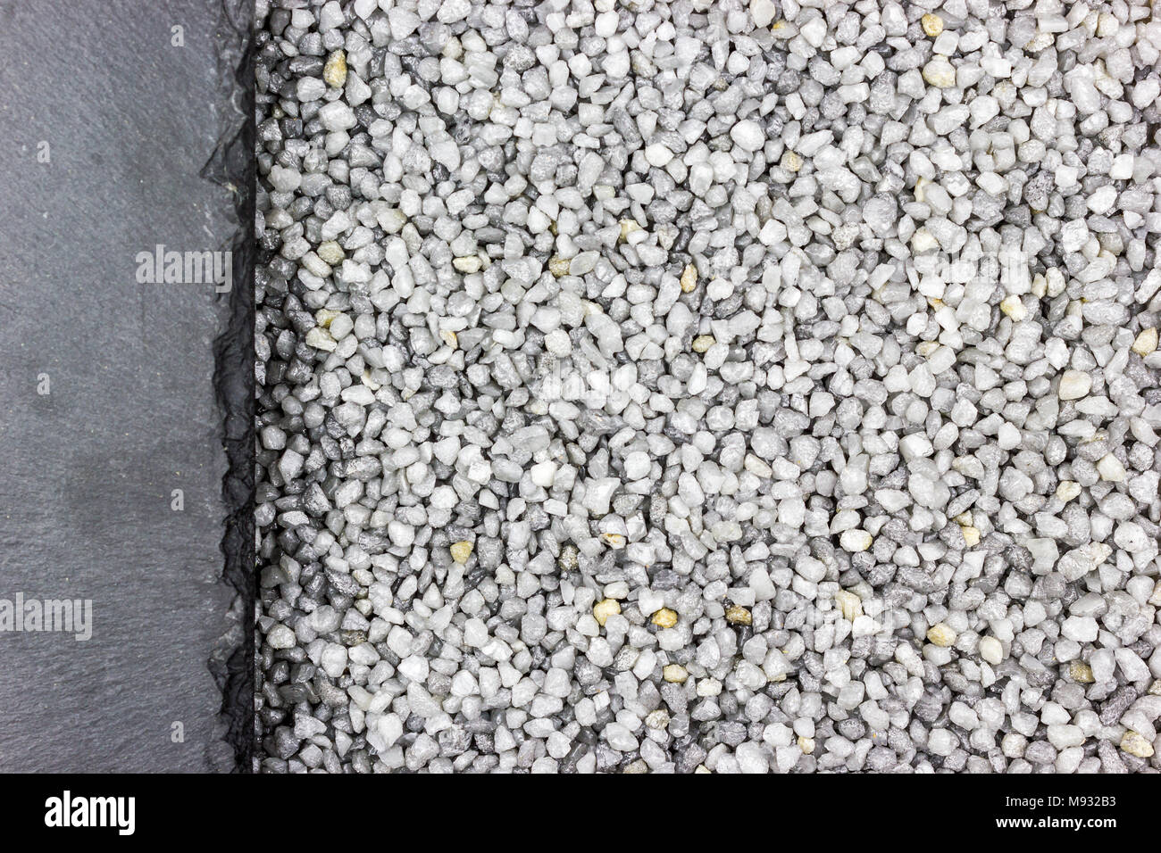 Grey fine gravel as background, place for text Stock Photo