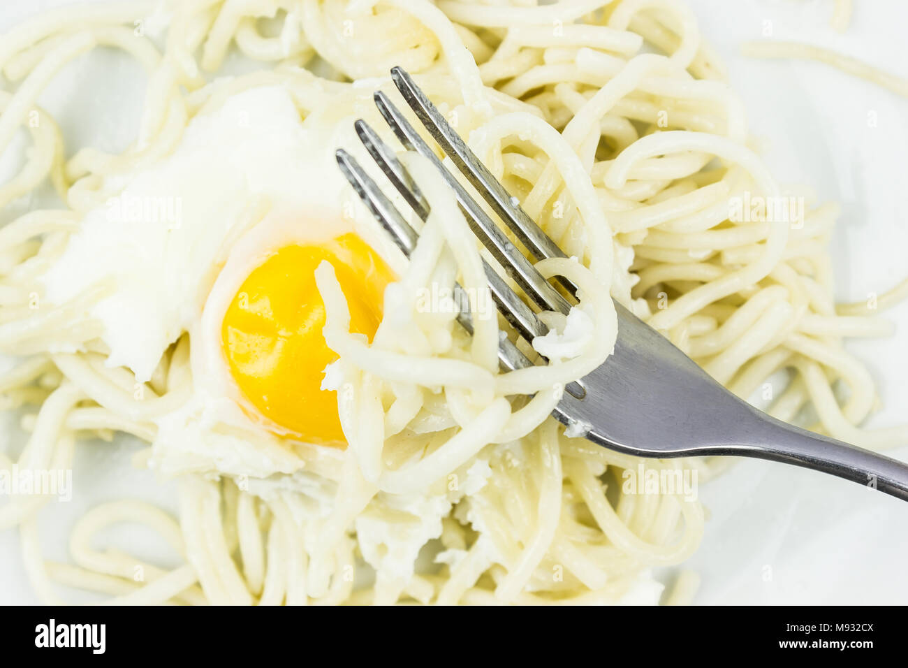 Scrambled eggs and spaghetti on the fork. Meals during lunch Stock