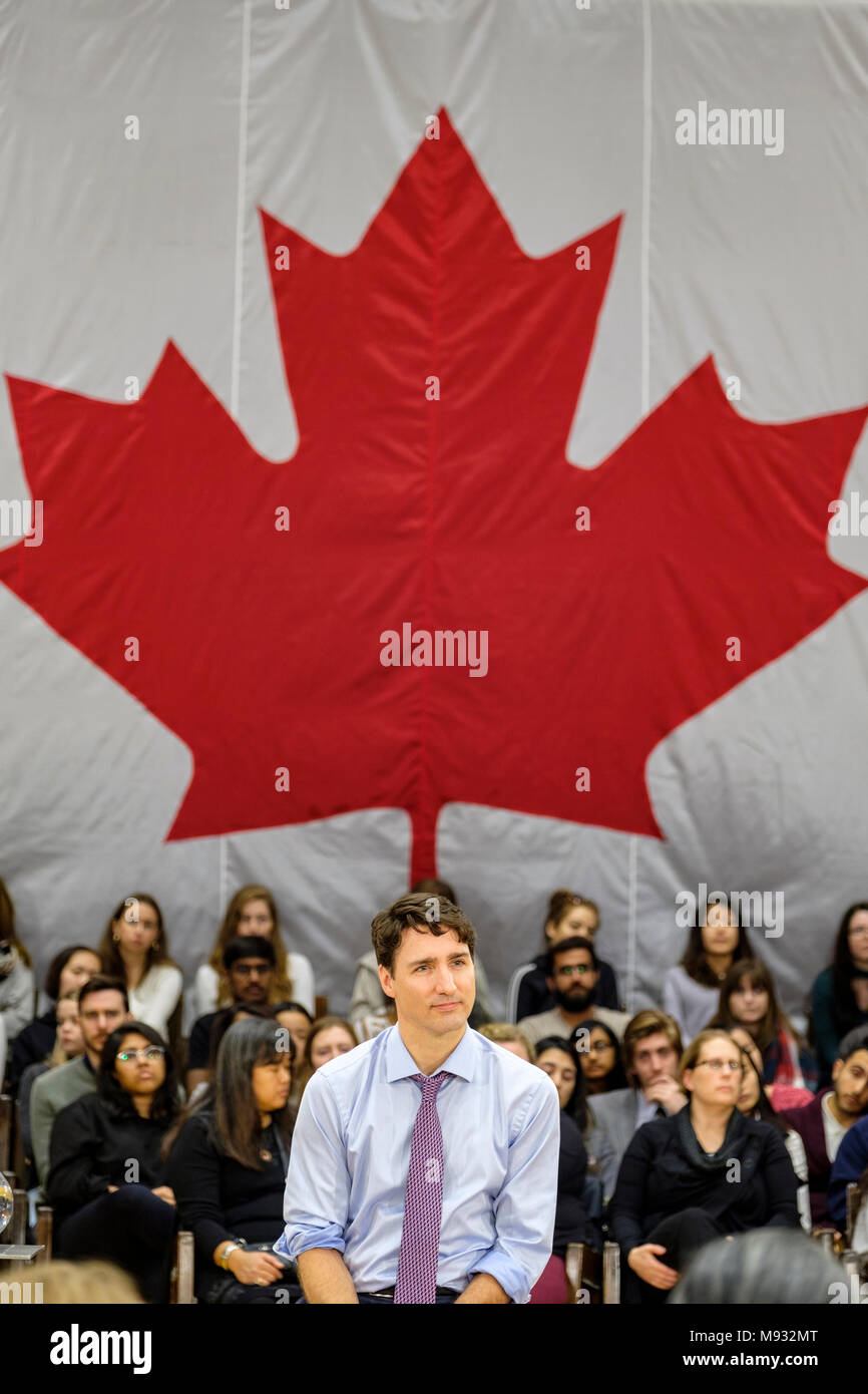 Justin Trudeau, Prime Minister of Canada, listening to questions at a town hall meeting in London, Ontario, Canada, with the Canadian flag in the back Stock Photo