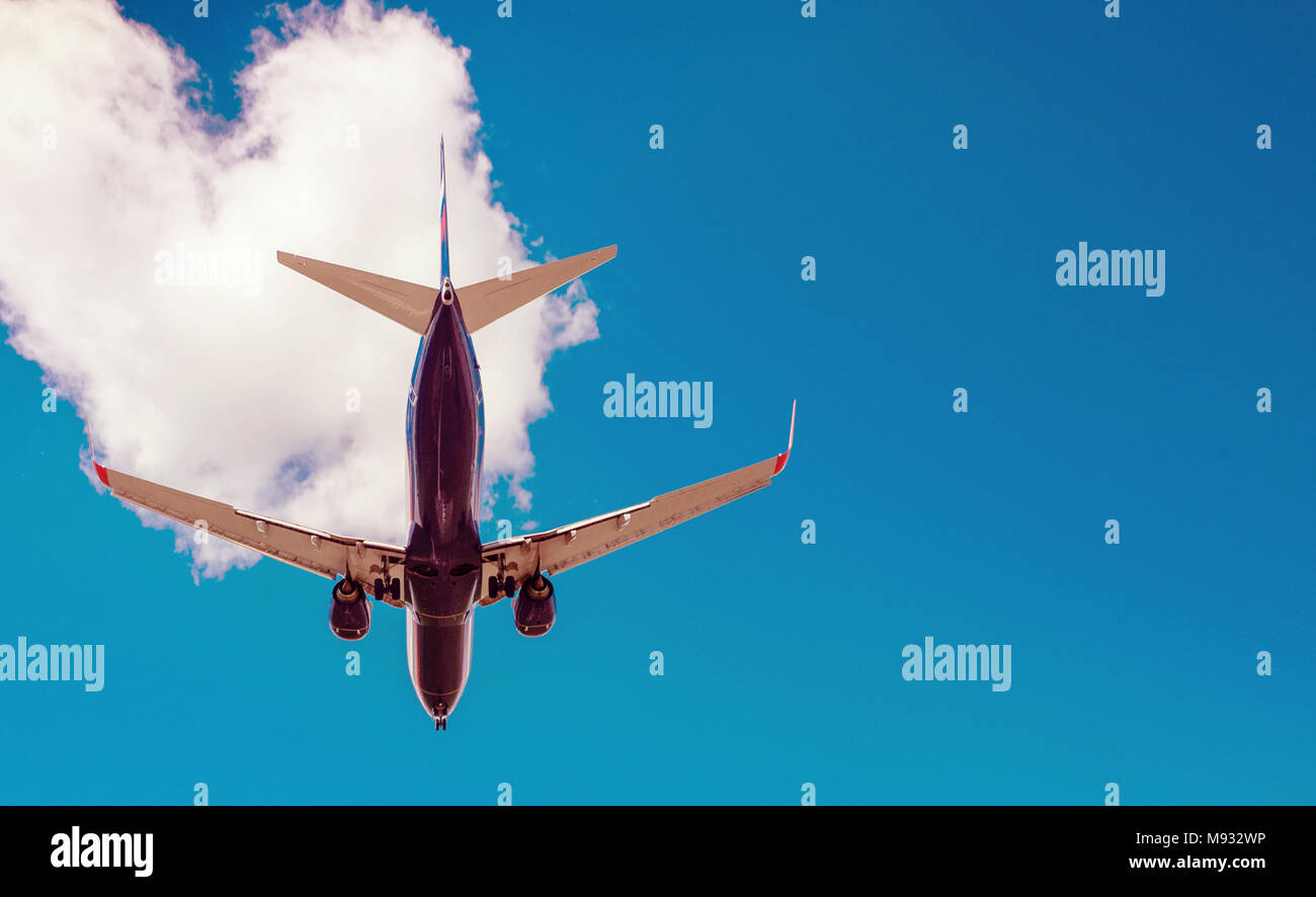 The plane on a background of blue sky and white clouds Stock Photo - Alamy