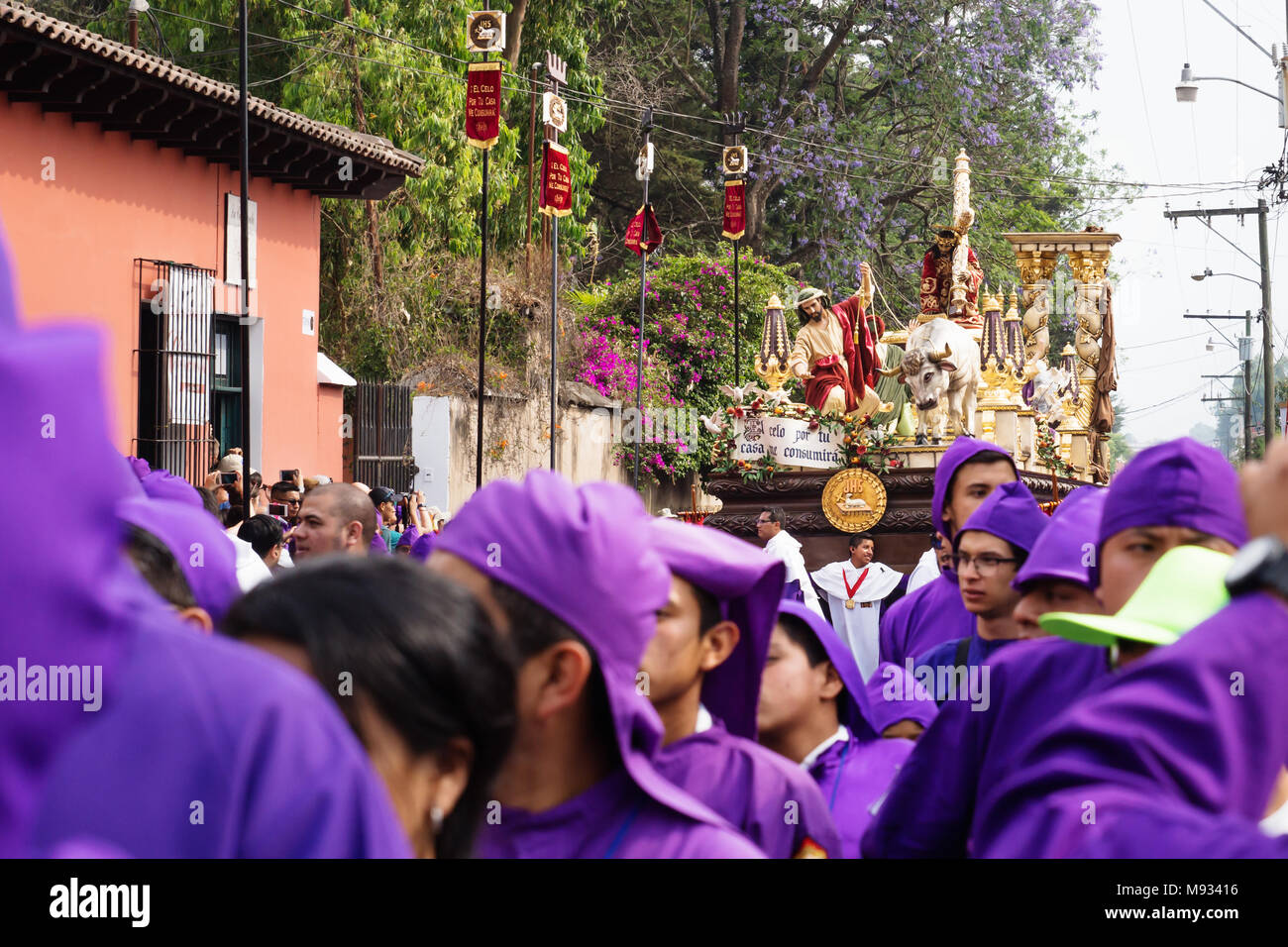 Altar boy in front of a float with Christ and a cross at the procession of San Bartolome de Becerra, Antigua, Guatemala Stock Photo