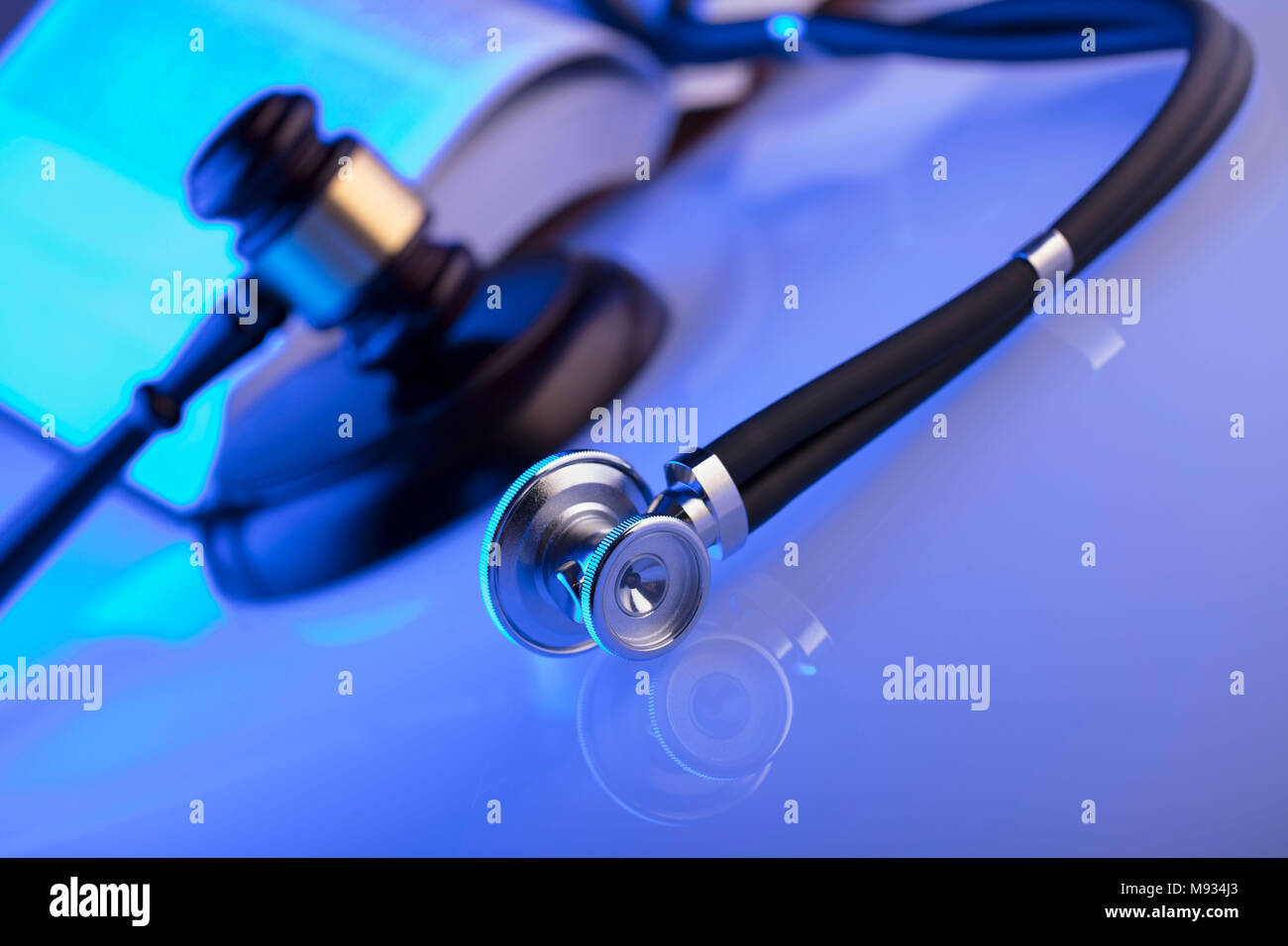 Medical law concept. Gavel and stethoscope, blue light. Place fort text. Stock Photo