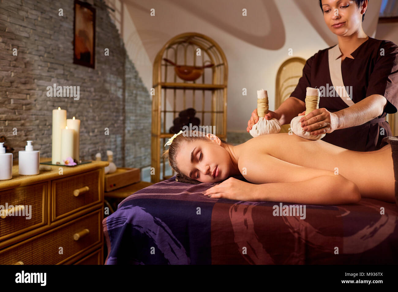 Close-up of a girl massage with bags in spa salon Stock Photo