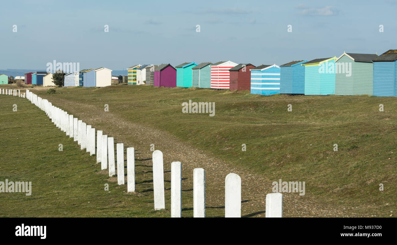 Colourful English seaside beach huts on the coast at New Romney, Kent, England, UK Stock Photo
