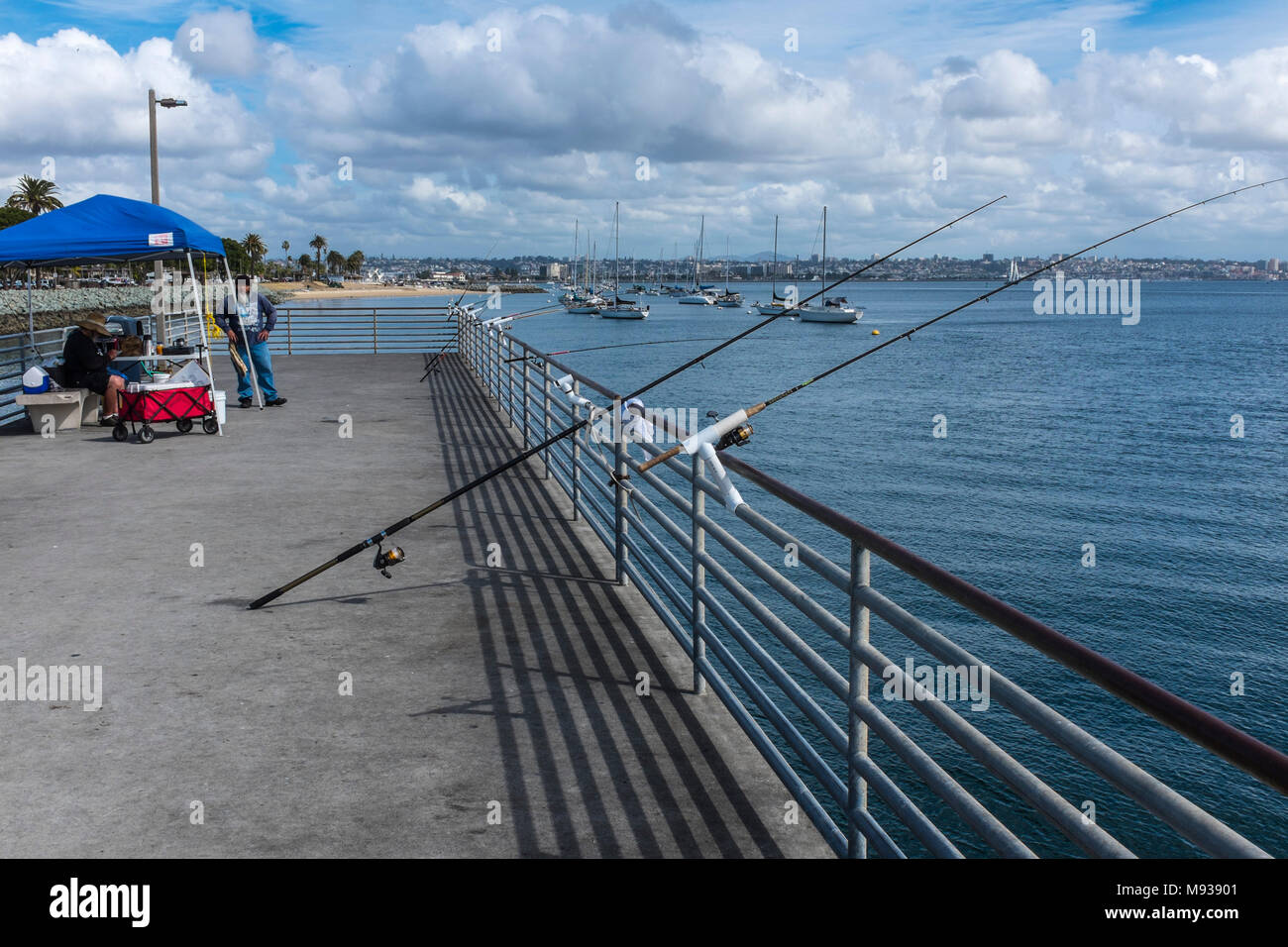 SAN DIEGO, CALIFORNIA, USA - Fishing rods on the pier at Shelter Island in San Diego. Stock Photo