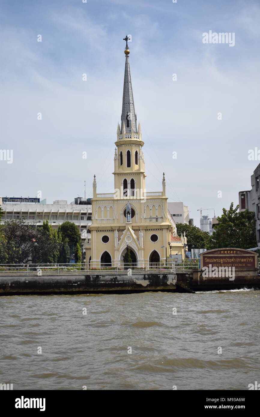 Old isolated catholic church by the main river in Bangkok with colorful beige and yellow paints, Thailand. Stock Photo