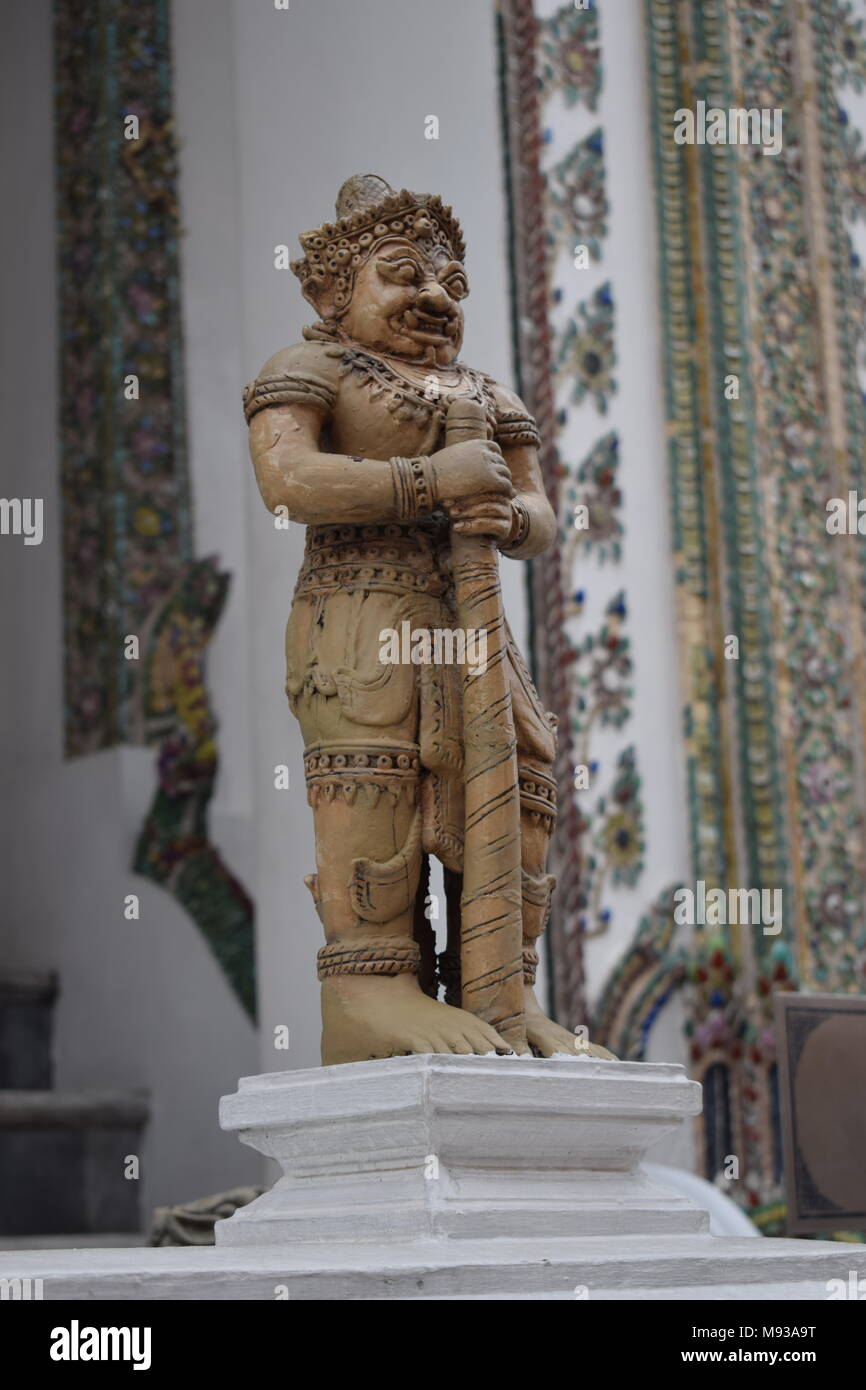 In Focus small ivory color statue in the front of the big palace in