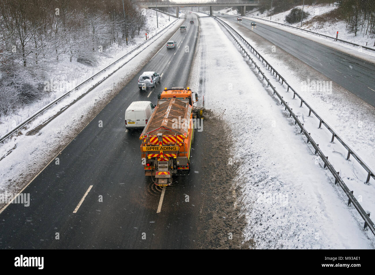 Snow plough and gritting vehicle on the M60 motorway after a snow fall, Ashton-under-Lyne, Tameside, Manchester, England, UK Stock Photo
