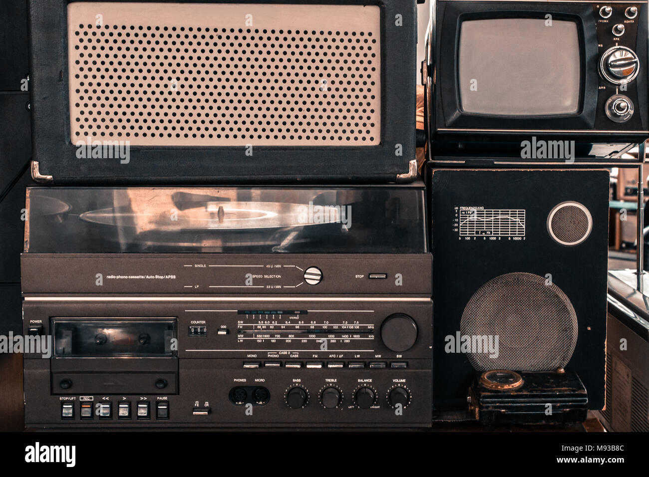 Old vintage audio system with radio, cassette tape recorder, record player, TV set, acoustic speakers Stock Photo