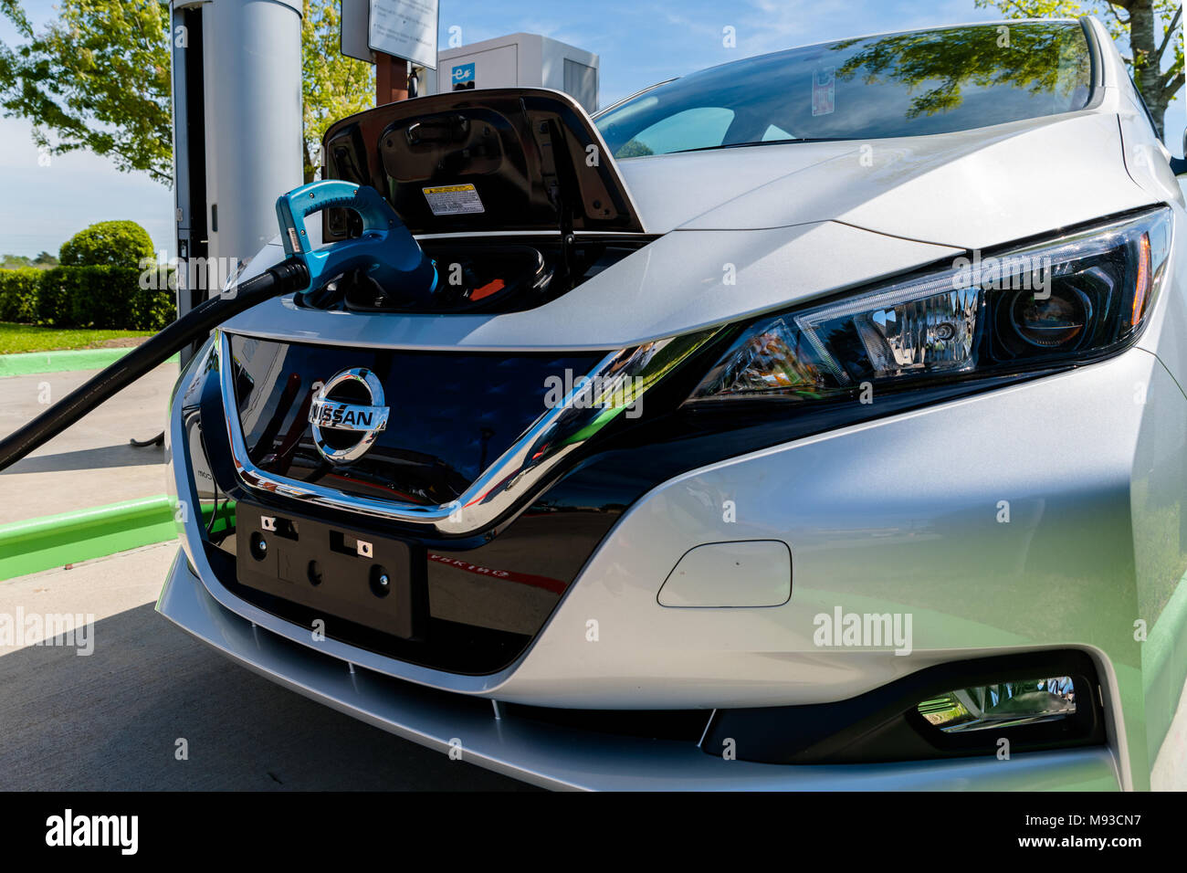 Pearland, Texas - March 21, 2018: New 2018 Nissan Leaf electric car plugged in to charge battery at the EVgo charging station Stock Photo