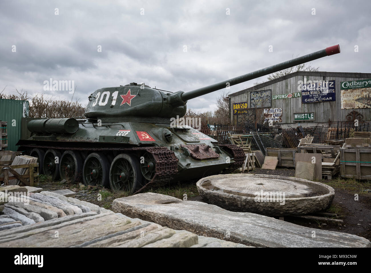 A T-34 Tank, a relic of the Soviet Union during World War II, slowly decays whilst waiting for sale in a Somerset reclamation yard, UK. Stock Photo